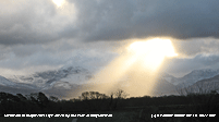 Crepuscular rays obscure view of snow on the Carneddau.