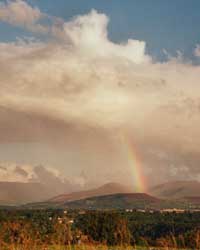 Rainbow over the Snowdonia Mountains seen across the Menai Strait from Four Crosses at 1825 GMT on 20 August 2000. Photo: © D Perkins.