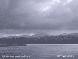 Light snow on the Snowdonia Mountains with high tide at beaumaris.
