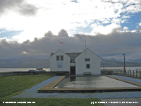 Beaumaris Lifeboat Station with cumulus over the mountains.