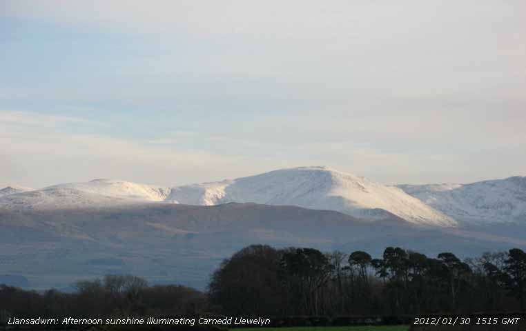 Afternoon sunshine on snow covered Carnedd Llewelyn.