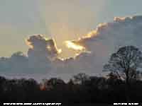 Backlit cumuli with crepuscular rays near sunset.