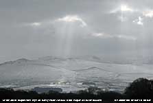 Crepuscular rays over the snowclad lower slopes of the Carneddau.