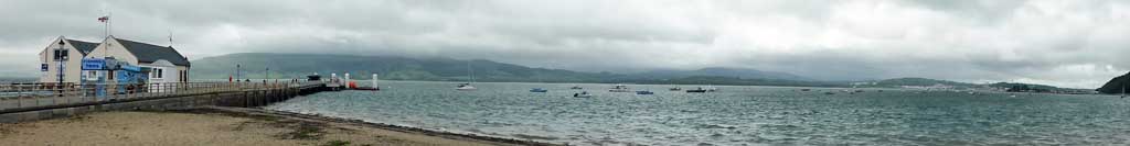Beaumaris pier and lifeboat station on a cloudy and breezy morning.